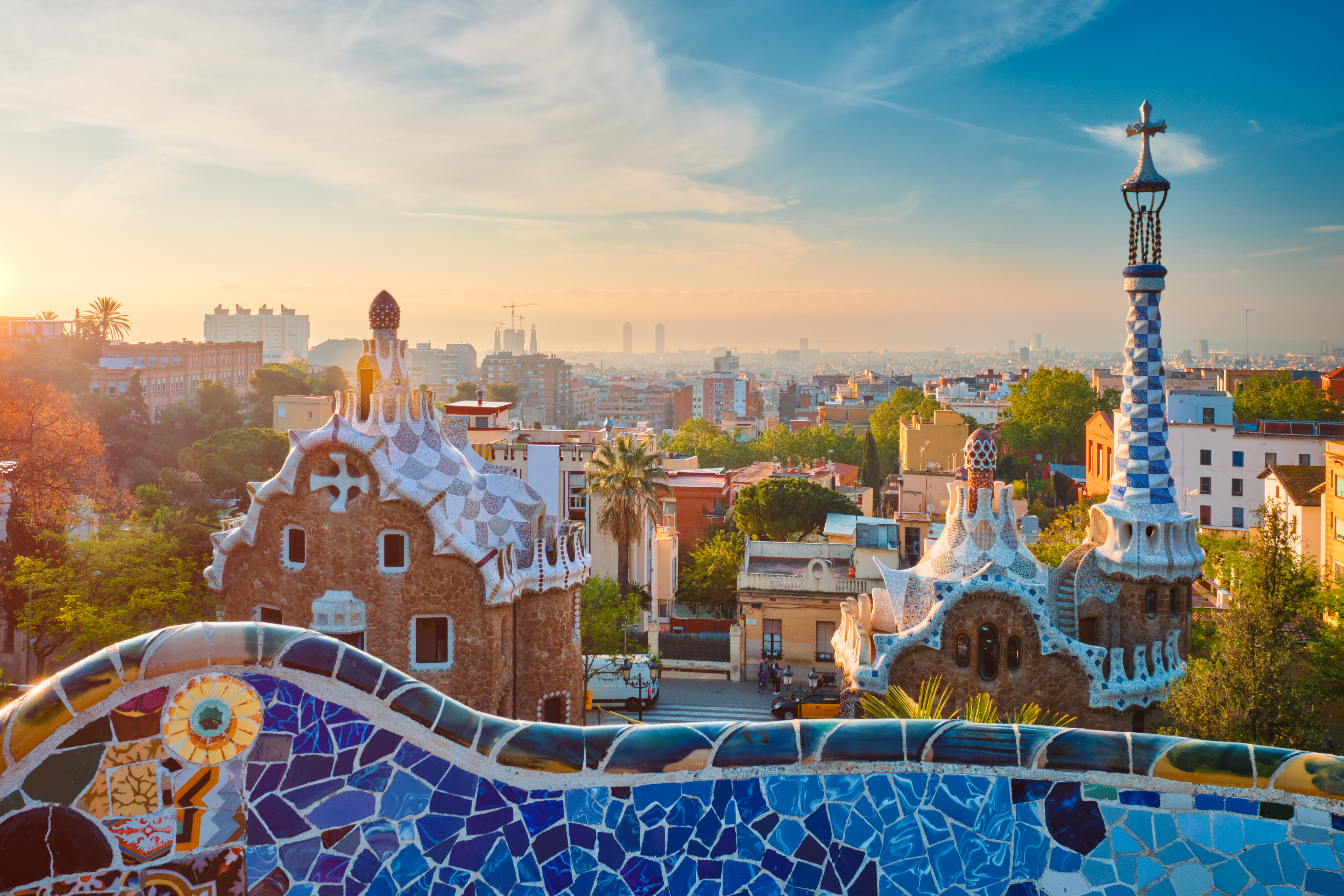 Barcelona city view from Guell Park. Sunrise view of colorful mosaic building in Park Guell