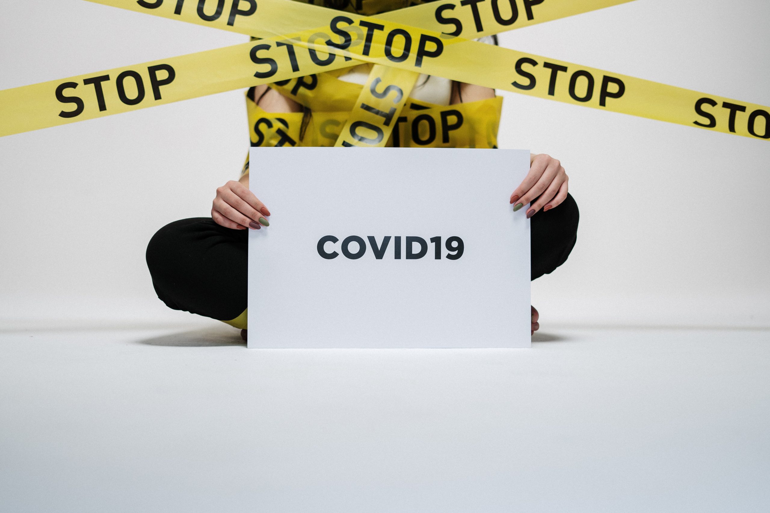 person-holding-covid-sign-3951600-scaled